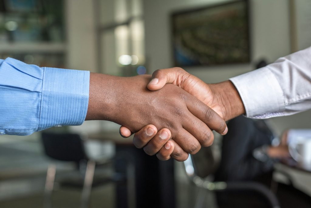 Two people shaking hands after agreeing insurance cover